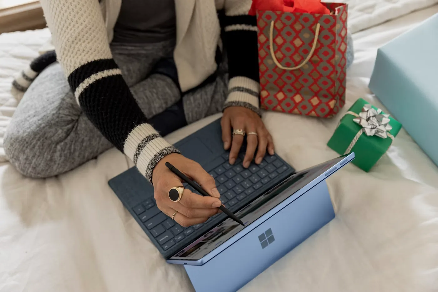 Person using a laptop to compare eCommerce platforms and plan an online store build